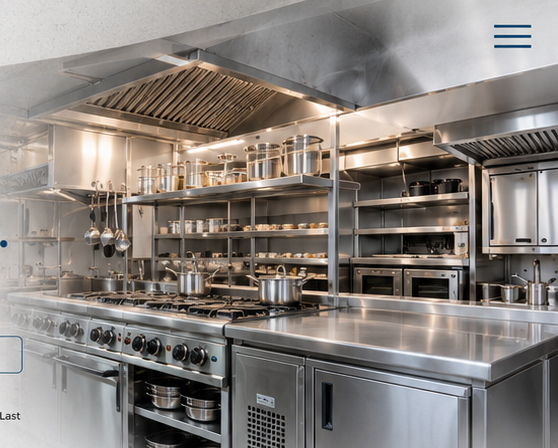 Stainless steel commercial kitchen with exhaust hood, ranges and shelving